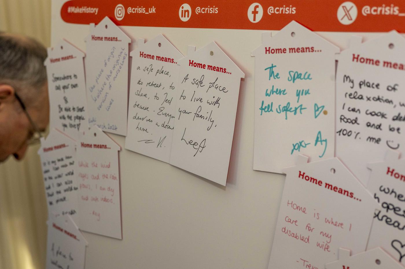 A board with handwritten messages about what home means